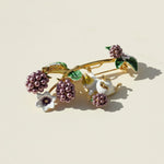 Decorative brooch with berries and flowers on a beige background