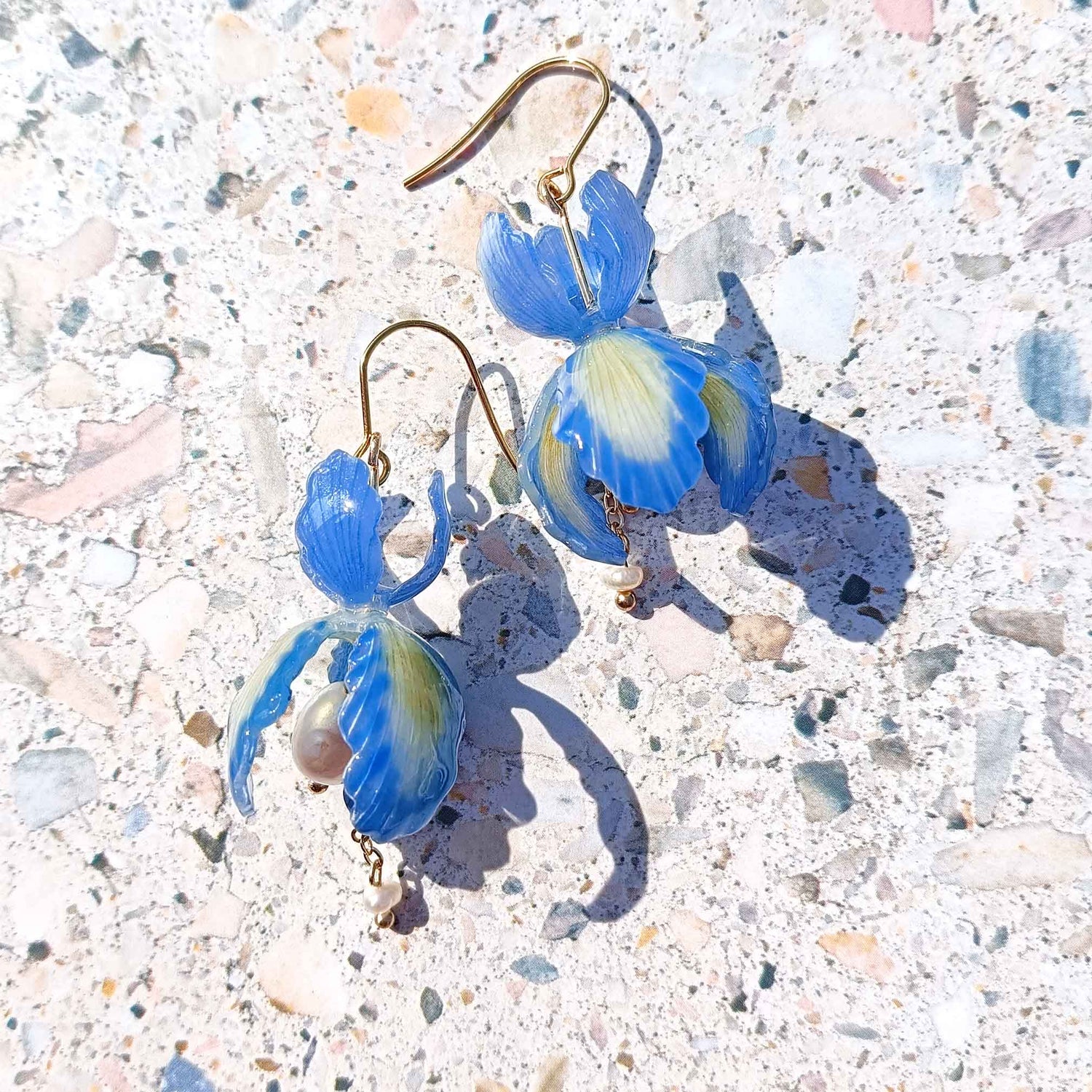 Handpainted blue iris flower earrings with green resin petals, pearl center, freshwater pearl drop, and gold-plated stainless steel hooks