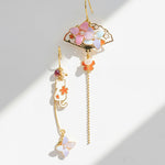 Decorative earrings with floral designs on a light background