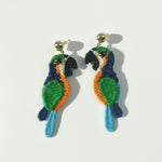 Crocheted parrot earrings on a light gray background