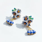 Floral earrings with blue and gold accents on a white background