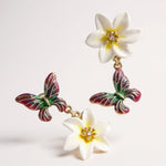 Butterfly and flower earrings on a white background