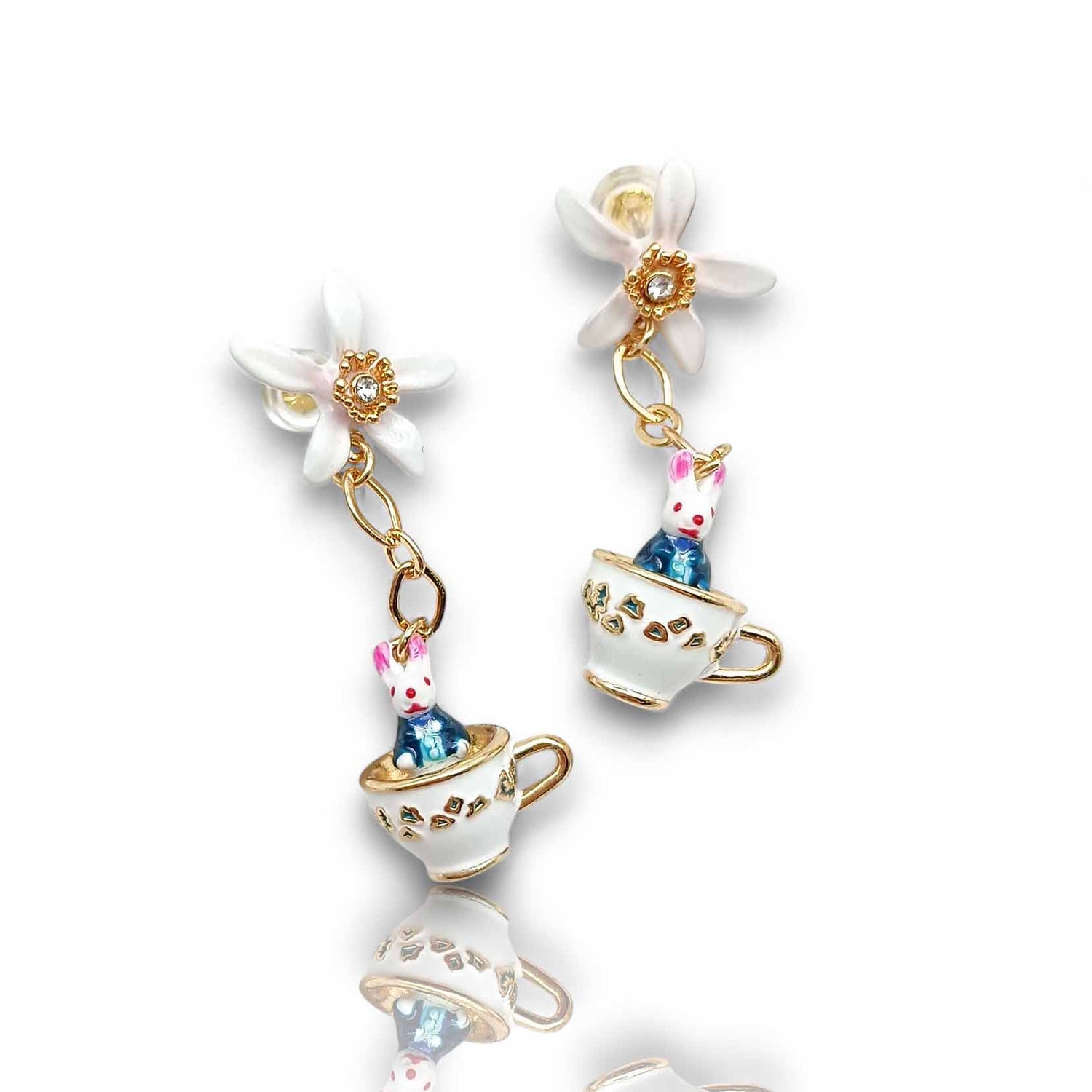 Pair of earrings with teacup and rabbit design on a white background