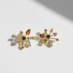 Multicolour starburst CZ stud earrings in gold plated brass on white background, sparkling crystal design by A2K London.