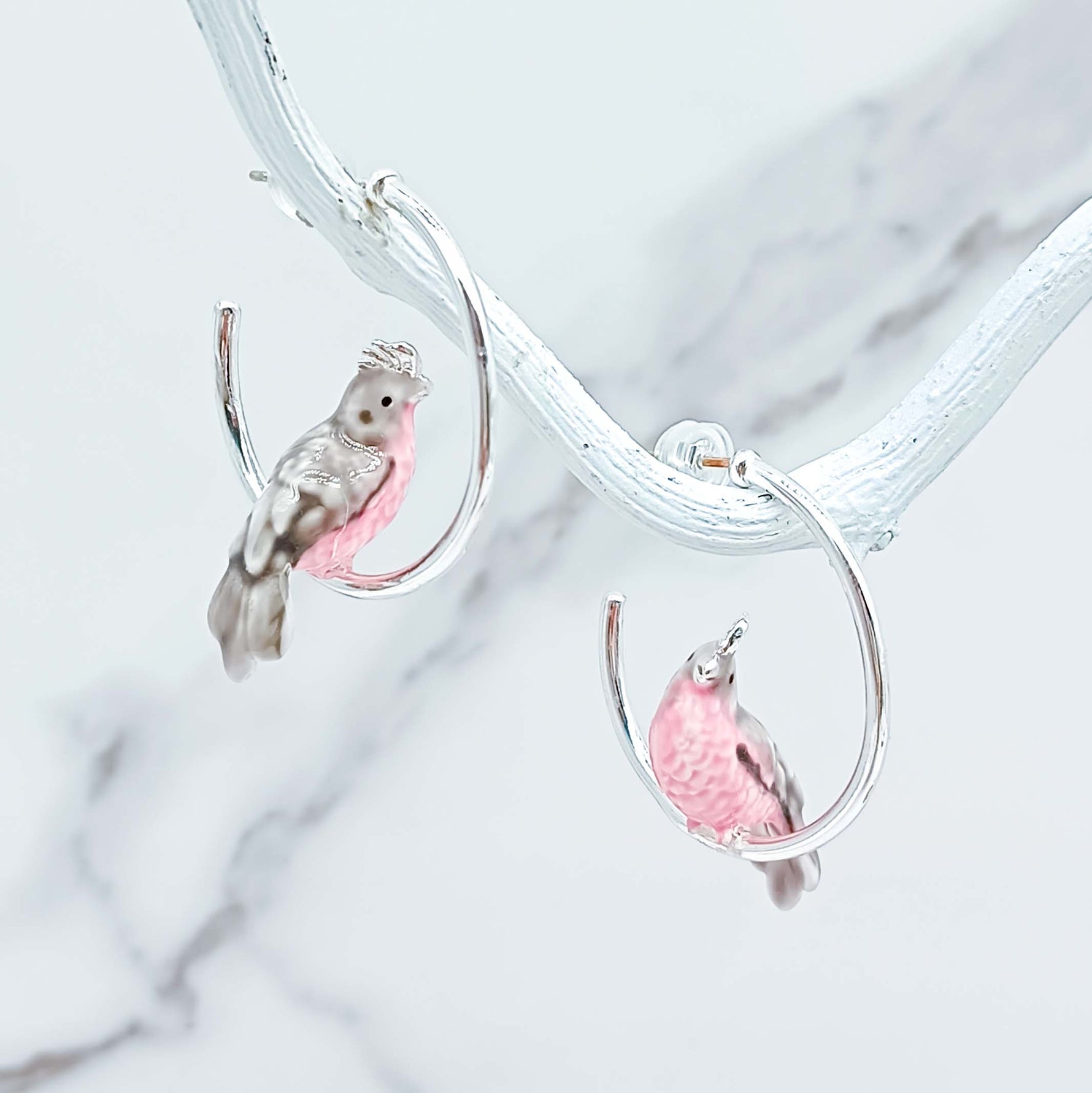 Cockatoo earrings on a marble background
