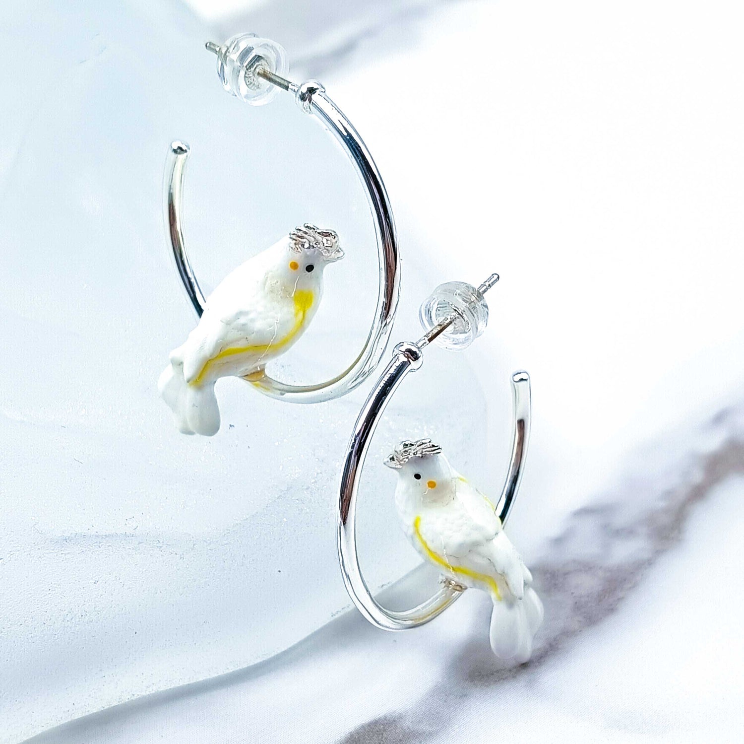 Cockatoo earrings on a white background