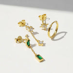 Gold earrings with gemstones on a white background