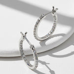 Sparkling D/VVS1 moissanite inside-out hoop earrings showing full pavé detail.