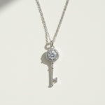 Sterling silver key necklace with 1ct moissanite center and halo details