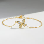 Gold-plated moissanite butterfly bracelet with 11mm pendant on a light surface