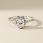 Sterling silver engagement ring with oval-cut lab-grown diamond and halo setting