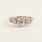 Rose gold engagement ring with marquise-cut lab-grown diamond and cluster accent stones