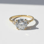 Gold 3ct round brilliant lab grown moissanite ring on white background