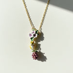 Necklace with floral and berry pendant on a light background