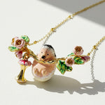 Necklace with a hedgehog and floral pendant on a light background