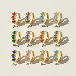 Gold-plated silver hoop earrings with CZ birthstones in 12 colors representing each birth month, by A2K London.