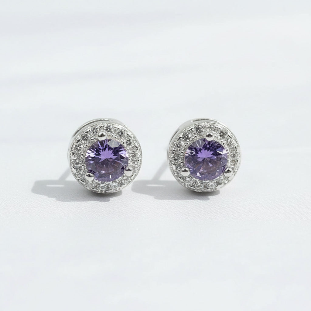 Silver stud earrings with platinum plating and purple birthstone center, surrounded by clear CZ halo.