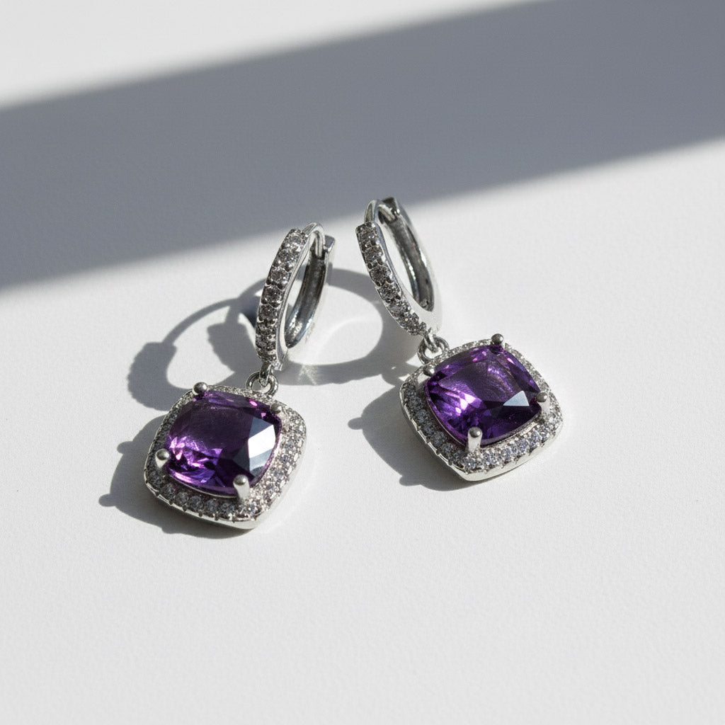 Amethyst birthstone dangle earrings with cushion-cut purple stones and halo CZ, platinum-plated silver leverback design.