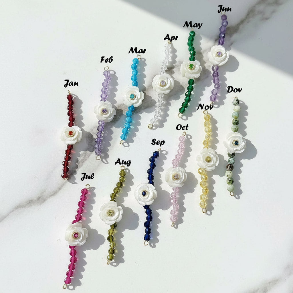 Birthstone flower bracelets in 12 colours for each month, featuring white carved flower charms with gemstone beads.