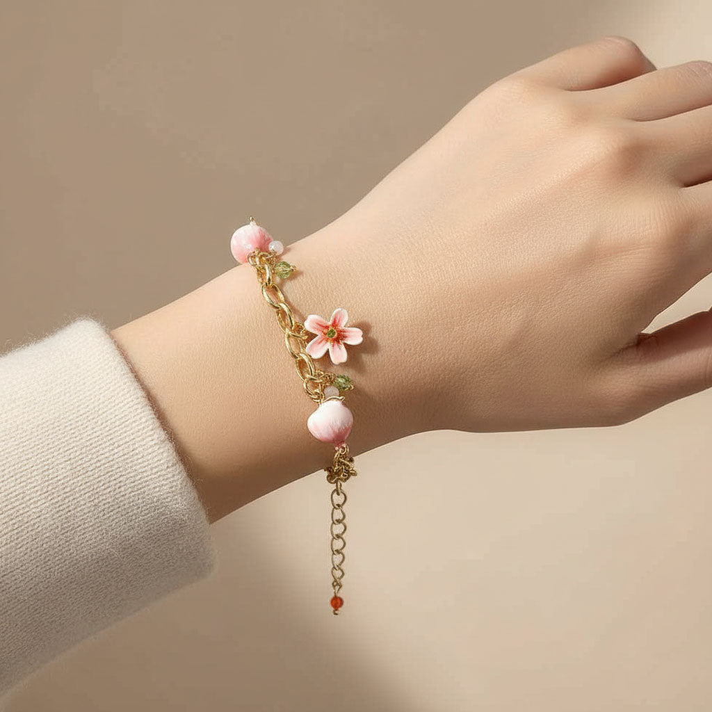 Hand wearing a delicate bracelet with pink beads and floral elements on a beige background