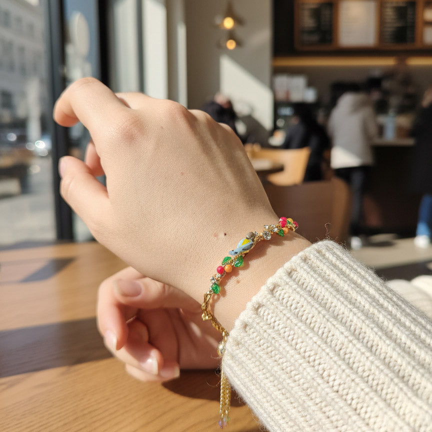 Hand wearing a colorful beaded bracelet with a blurred cafe background