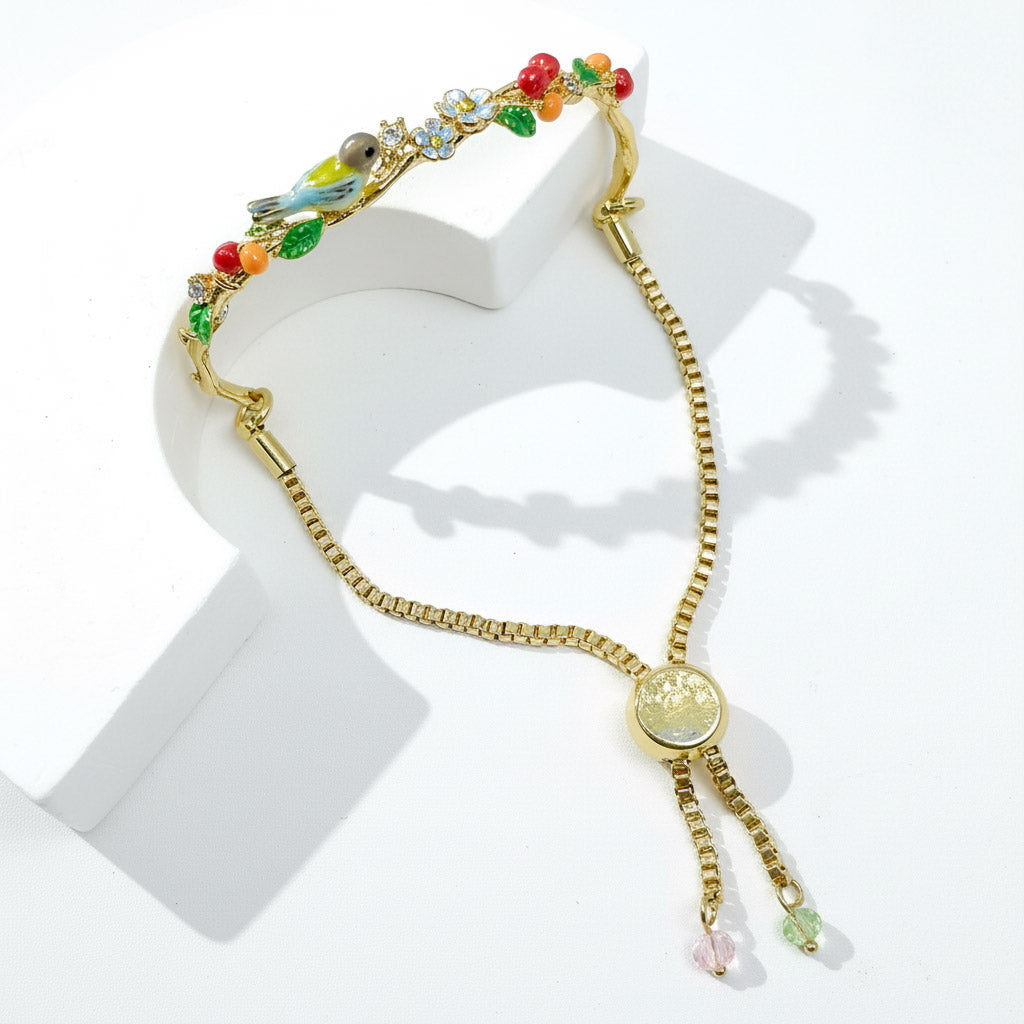 Gold bracelet with colorful charms on a white background