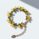Yellow berry garden bracelet featuring semi-precious stone clusters and olive green enamel leaves with a gold-tone finish