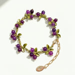 Plum berry garden bracelet with purple semi-precious stone clusters and green enamel leaves in a handcrafted design