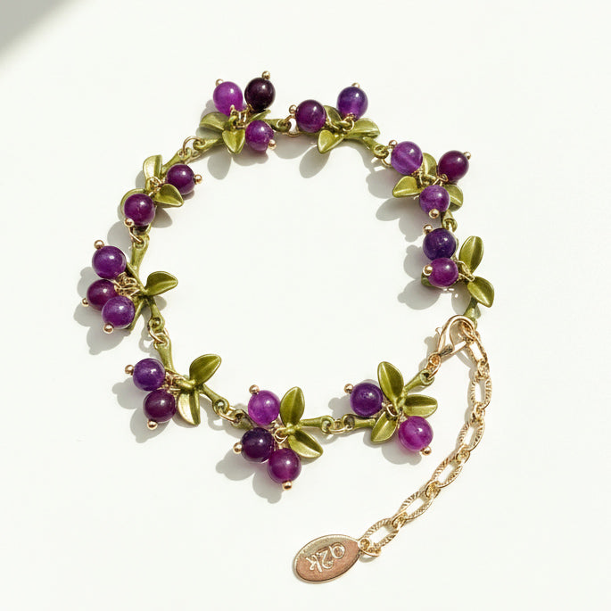 Plum berry garden bracelet with purple semi-precious stone clusters and green enamel leaves in a handcrafted design