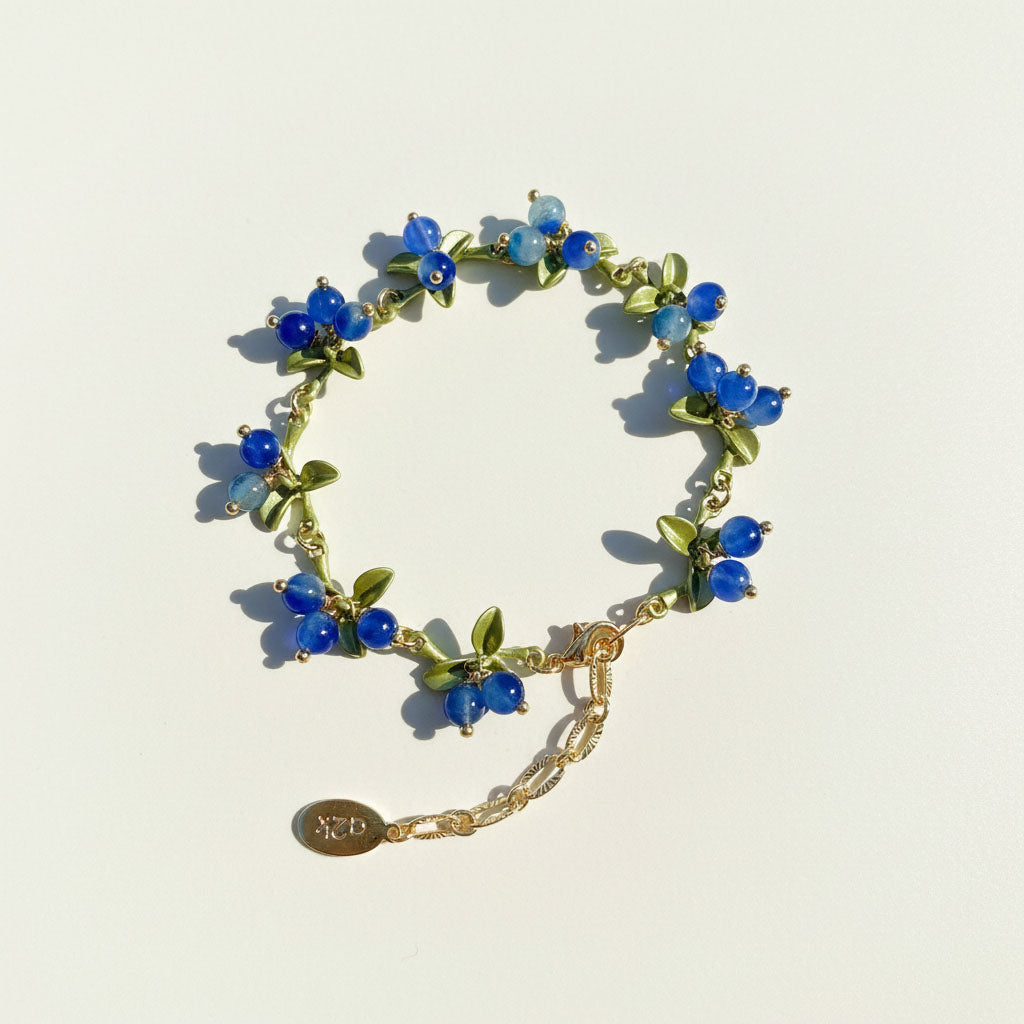 Bracelet with blue and green beads on a light background