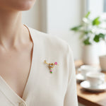 Person wearing a decorative brooch on a blurred indoor background