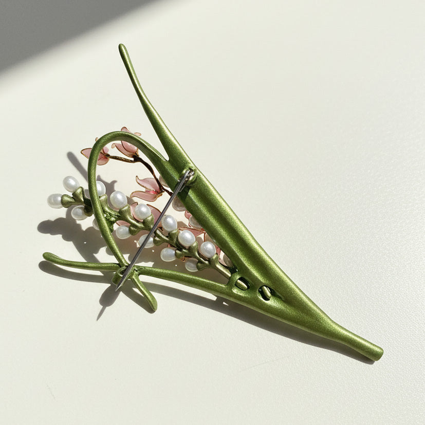 Back view of handcrafted enamel flower brooch with secure pin fastening