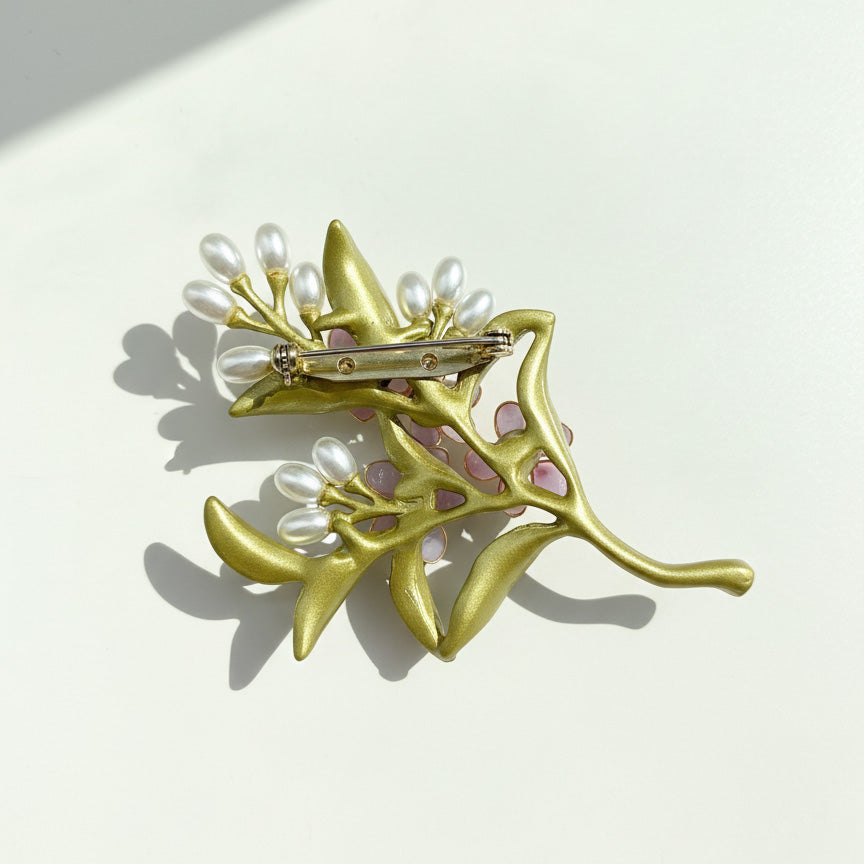 Back view of handcrafted resin flower brooch with metal pin fastening