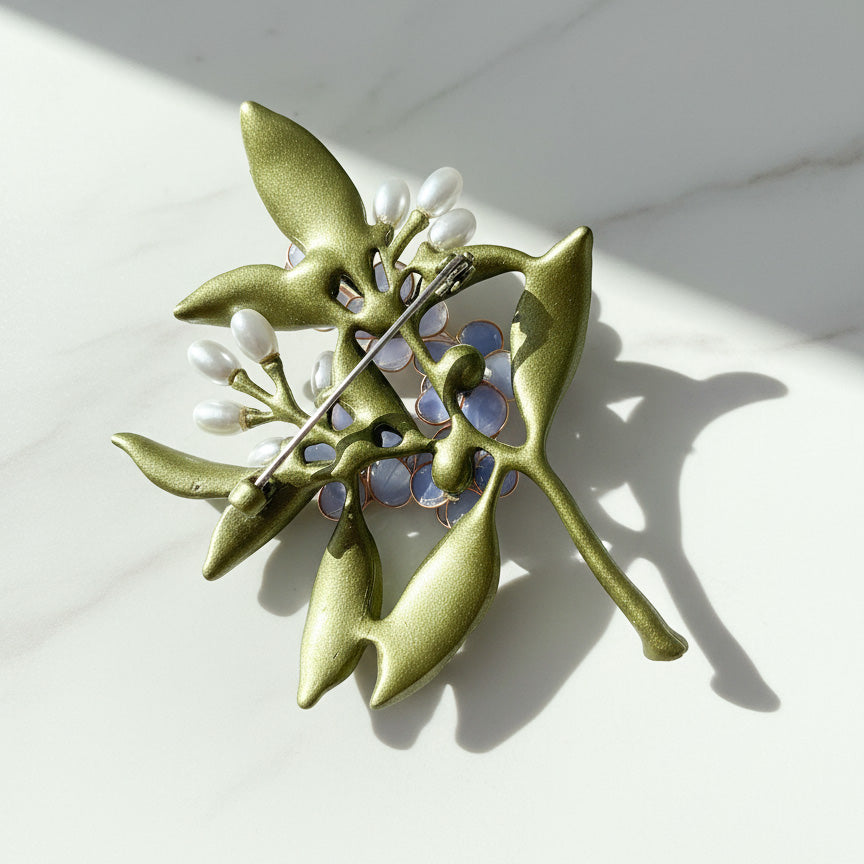 Back view of handcrafted blue floral brooch with metal pin fastening