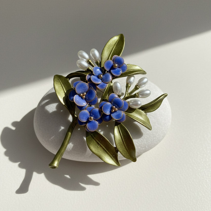 Handcrafted blue floral resin brooch with green leaves and pearl-like buds