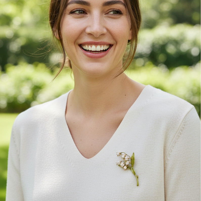 Woman wearing a white sweater with a floral brooch outdoors