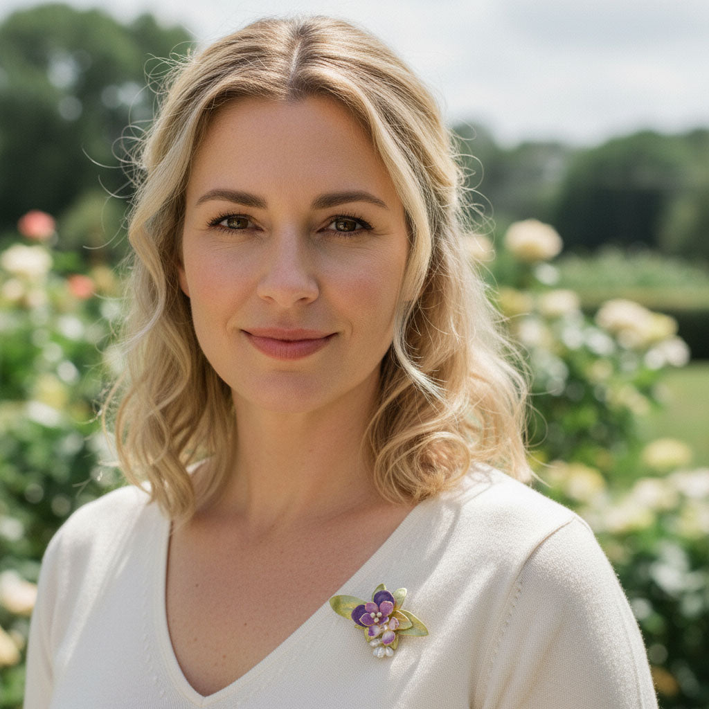 Model wearing handcrafted orchid floral brooch