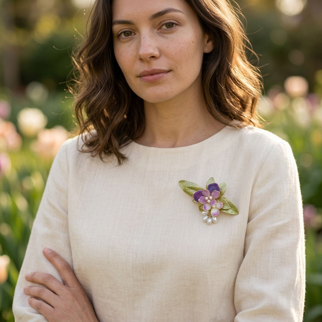 Model wearing handcrafted orchid floral brooch