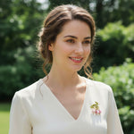 Woman in a white dress with a floral brooch outdoors