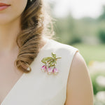 Floral pearl brooch styled on cream outfit outdoors