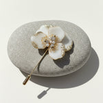 Handcrafted white floral resin brooch with freshwater pearls and gold foil accents
