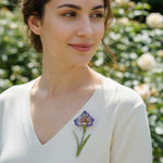 Purple flower resin brooch styled on knit top outdoors