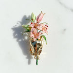 Hand-painted resin flower brooch with green leaves and bud details