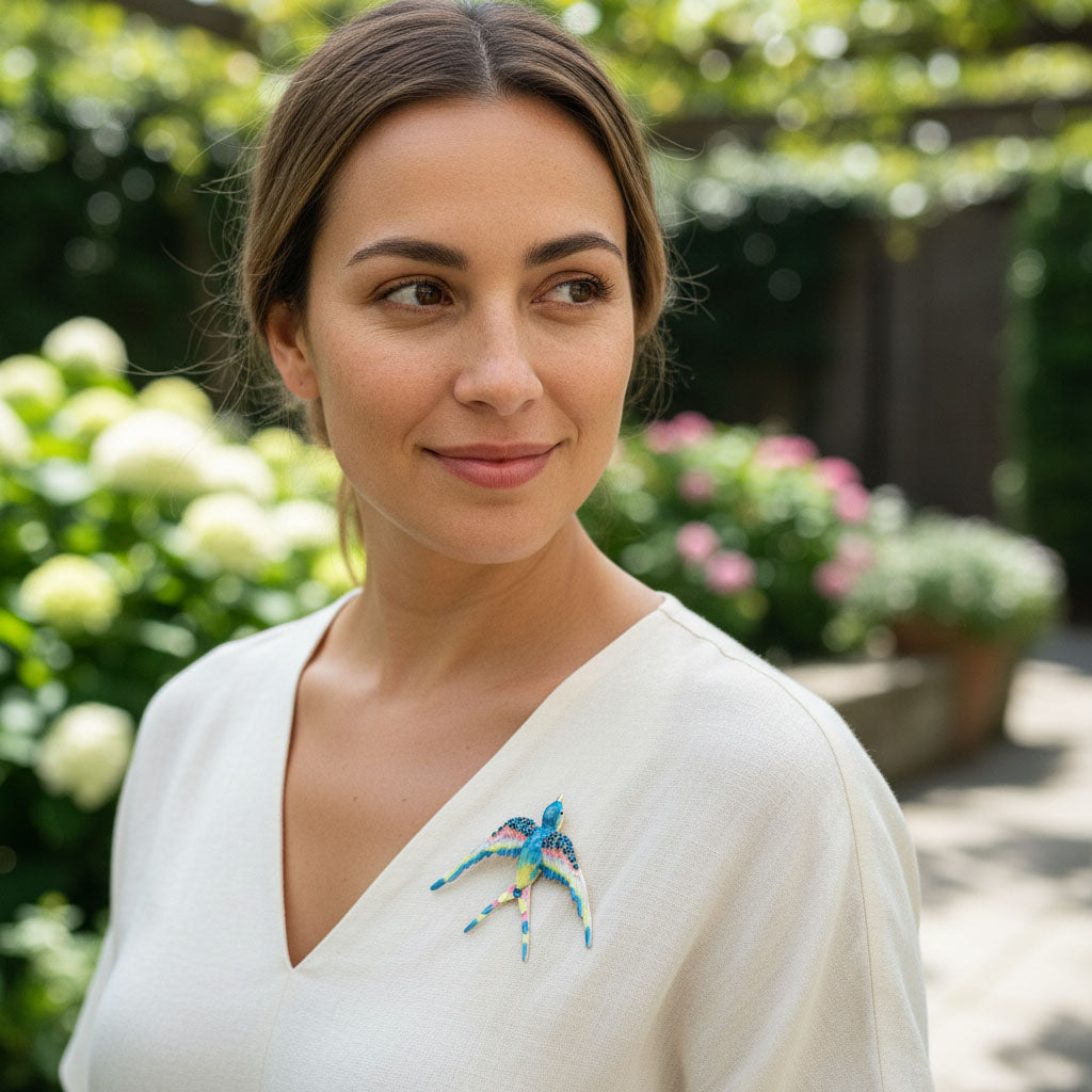 Woman wearing a colorful brooch in a garden setting