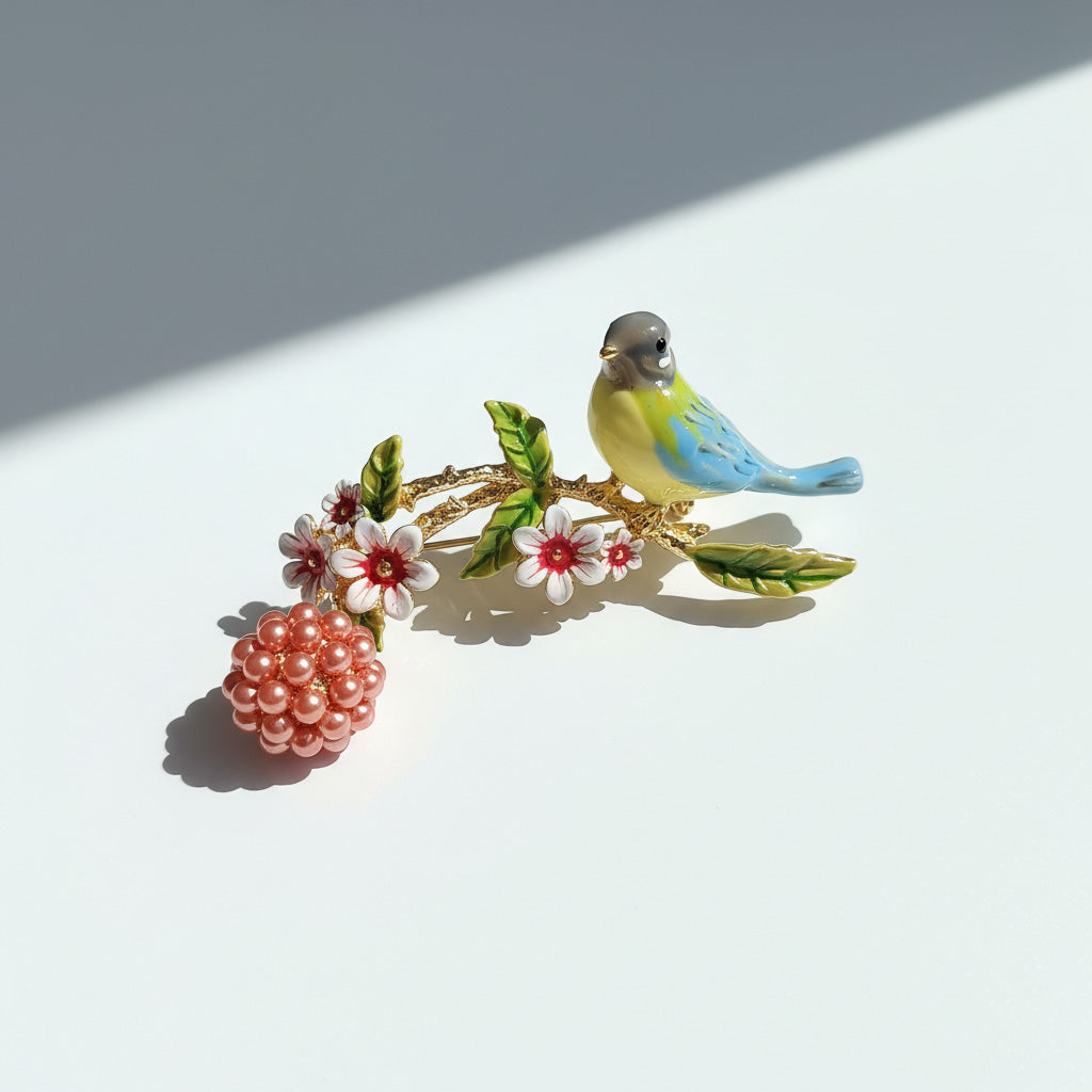 Decorative brooch with a bird and floral elements on a white background