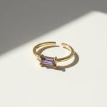 Gold-plated silver adjustable ring with rectangular purple CZ birthstone, minimalist open band design by A2K London.
