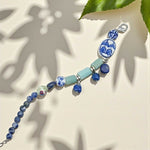 Porcelain bead and semi-precious stone bracelet with blue and green accents.