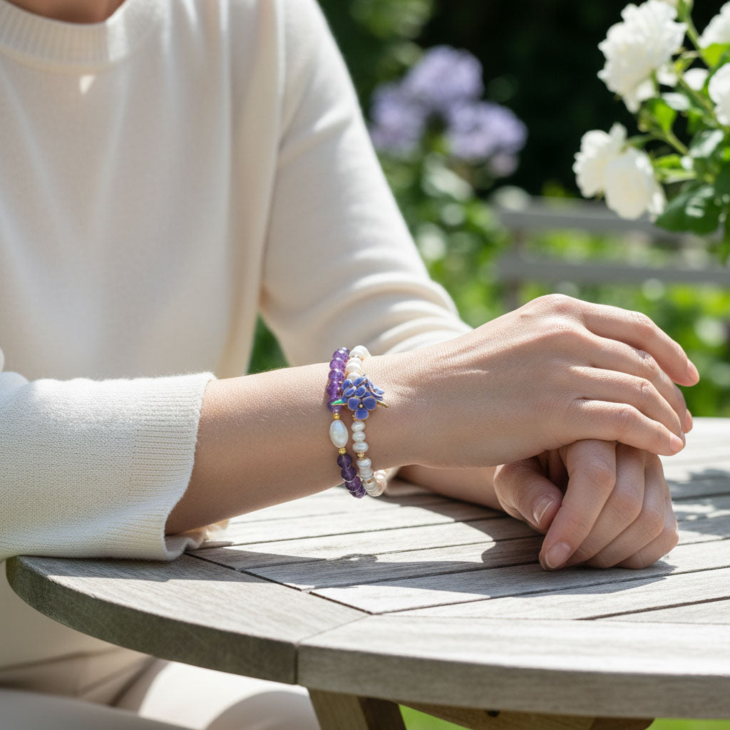 Person wearing a purple handcrafted resin flower with amethyst beads on a wooden table outdoors