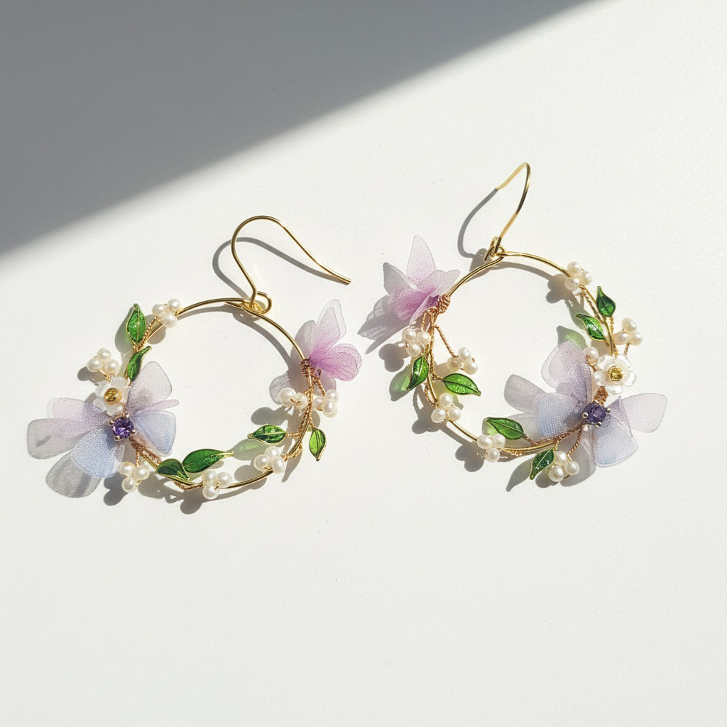 Floral hoop earrings with gold accents on a white background