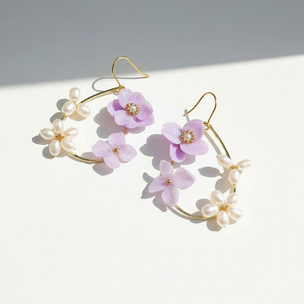 Floral and pearl earrings on a light background